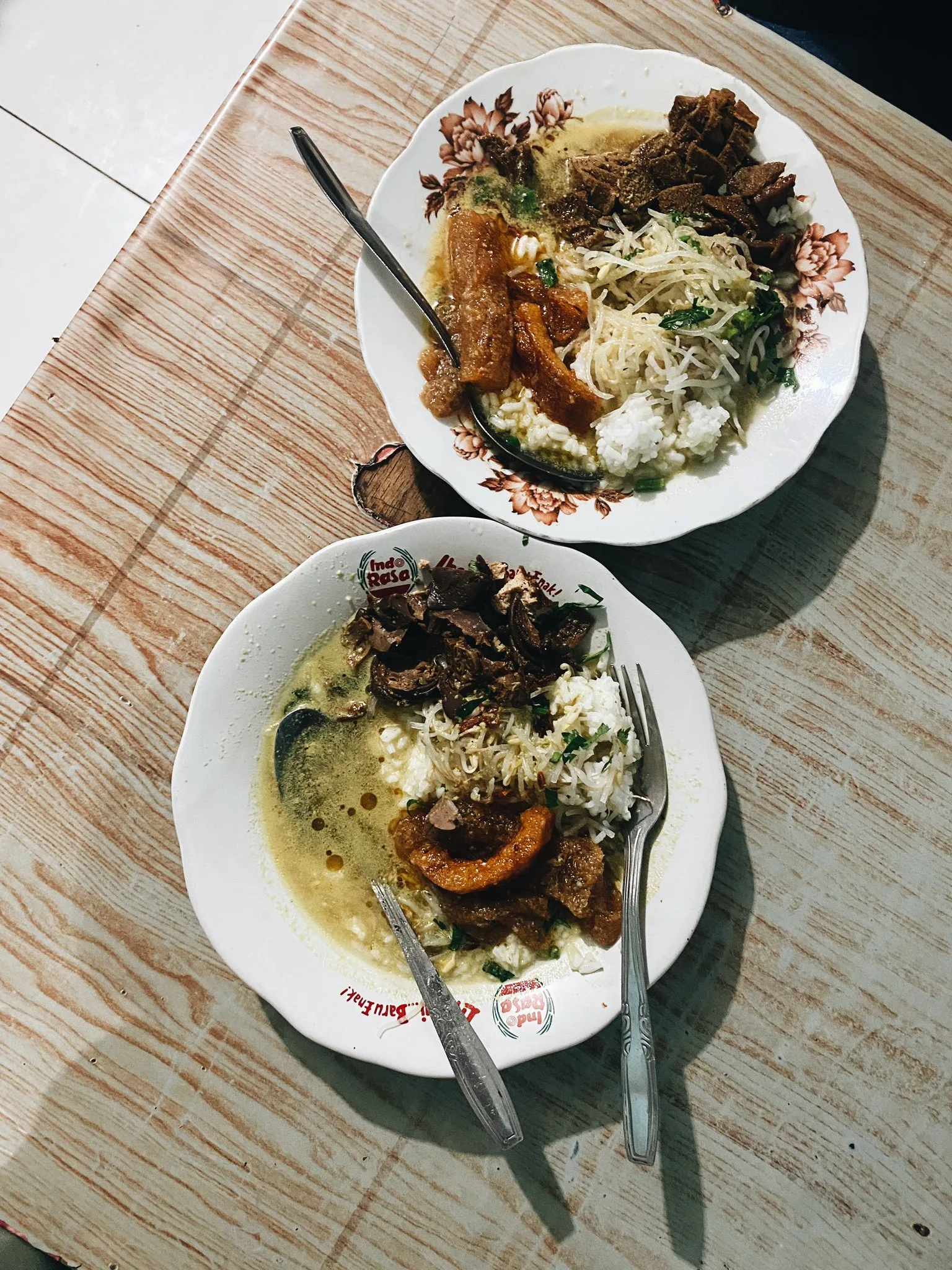 Two bowls of Kupat Tahu Magelang served together