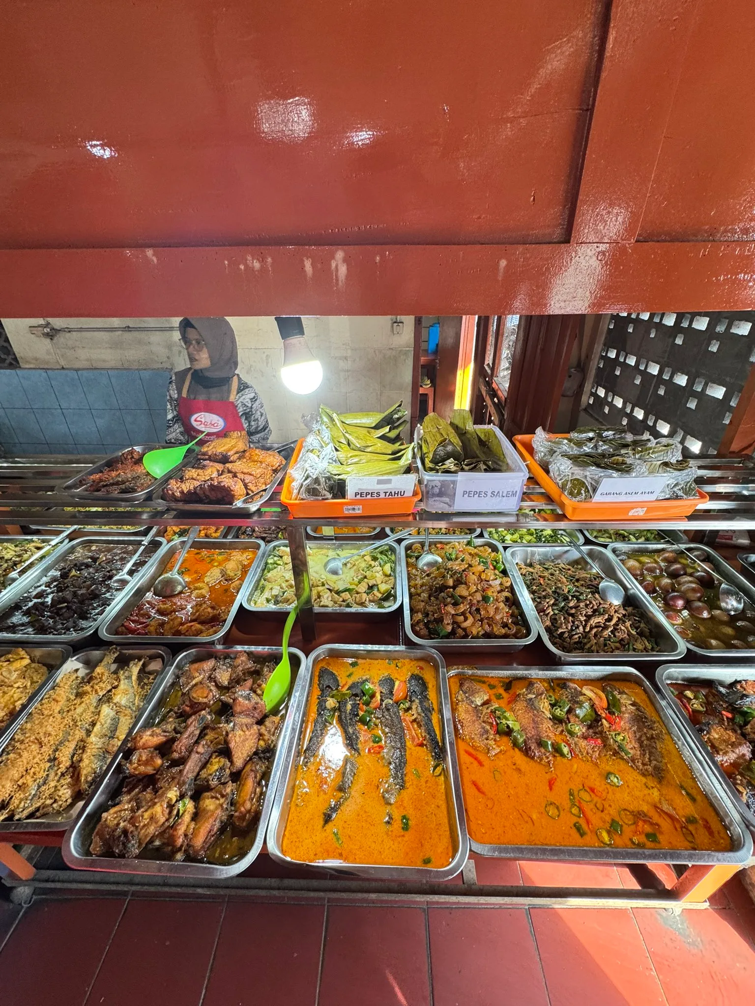 Trays of ready dishes arranged at a local warung in Magelang