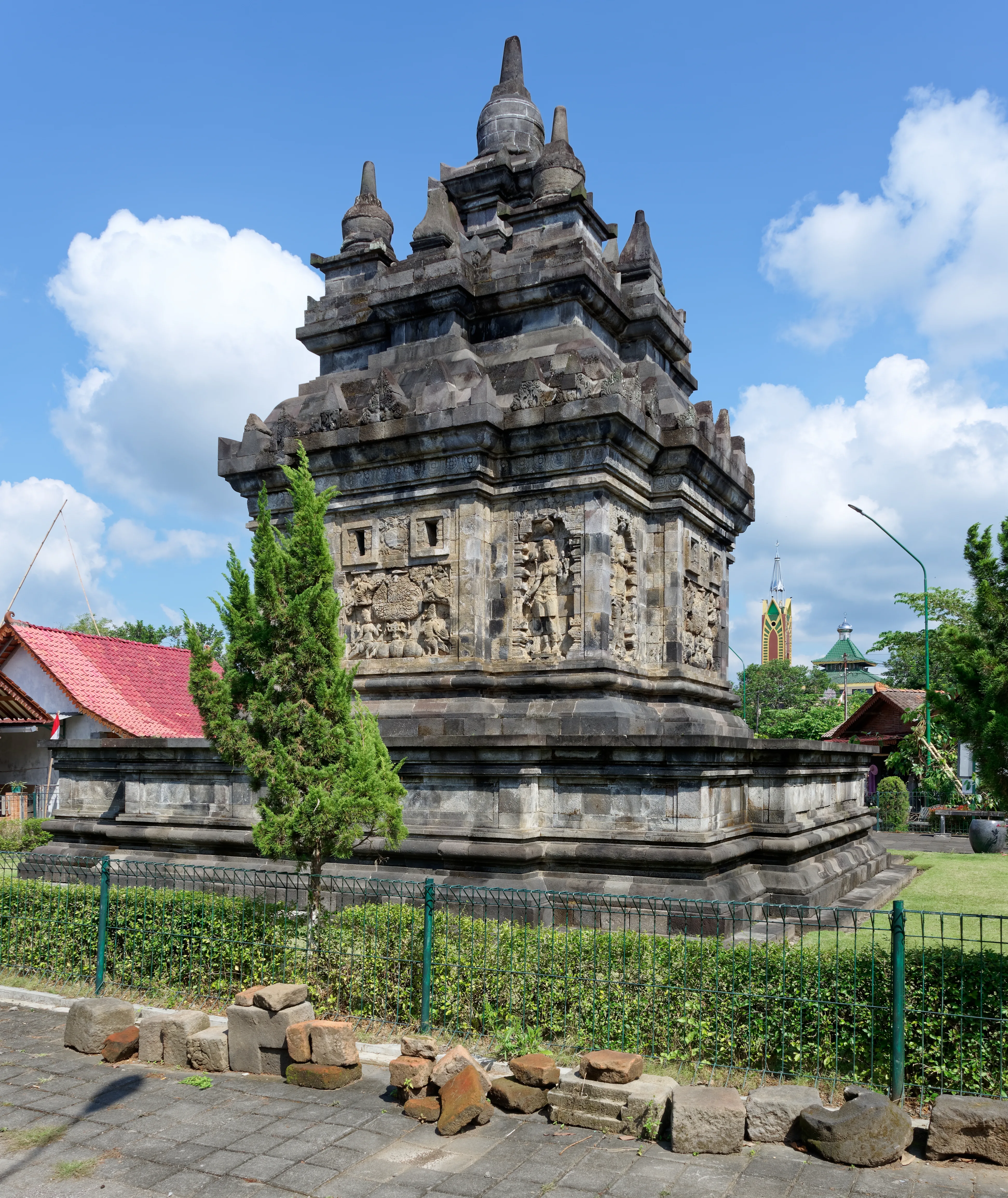 Stone Pawon Temple in Central Java framed by trees